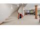 Finished basement with open floor plan, bar area, and staircase at 6722 S Wolff Ct, Littleton, CO 80128