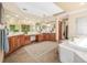 Spacious bathroom with double sink vanity, soaking tub, tile floor, and large mirror at 6722 S Wolff Ct, Littleton, CO 80128