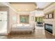Bright bathroom features a soaking tub, walk-in shower, and fireplace at 6722 S Wolff Ct, Littleton, CO 80128