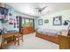 Bright bedroom with light blue walls, ceiling fan, and wooden furniture at 6722 S Wolff Ct, Littleton, CO 80128