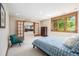 Bright bedroom with a large window, French doors and neutral décor at 6722 S Wolff Ct, Littleton, CO 80128