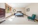 Comfortable bedroom with a large window, dresser and stylish chair at 6722 S Wolff Ct, Littleton, CO 80128