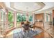 Breakfast nook with hardwood floors, large windows with wooded views, and decorative ceiling inset at 6722 S Wolff Ct, Littleton, CO 80128
