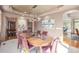 Spacious dining room with tray ceilings, hardwood floors, room to entertain Gathering and friends and flows to entry at 6722 S Wolff Ct, Littleton, CO 80128