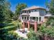 An elevated view of the home's deck, patio, lush lawn, and extensive landscaping at 6722 S Wolff Ct, Littleton, CO 80128