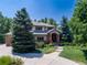 Charming two-story brick home with a landscaped front yard and paved driveway at 6722 S Wolff Ct, Littleton, CO 80128