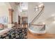 Grand foyer with hardwood floors, a curved staircase, and an elegant chandelier at 6722 S Wolff Ct, Littleton, CO 80128