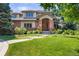 Beautiful brick home featuring a manicured lawn and lovely landscaping at 6722 S Wolff Ct, Littleton, CO 80128
