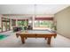 Basement game room includes a billiards table and multiple seating areas at 6722 S Wolff Ct, Littleton, CO 80128