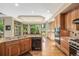 Open kitchen with stainless dishwasher, stainless gas range and oven, granite counters, and eat in breakfast nook at 6722 S Wolff Ct, Littleton, CO 80128