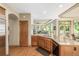 Kitchen offers an island with stainless steel appliances, granite counters, and hardwood floors overlooking living room at 6722 S Wolff Ct, Littleton, CO 80128