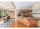 Spacious kitchen with granite countertops, custom cabinets, and a dining nook at 6722 S Wolff Ct, Littleton, CO 80128