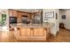 Kitchen island with granite counters and wood cabinets with stainless faucet, lots of counterspace, and hardwood floors at 6722 S Wolff Ct, Littleton, CO 80128