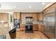 Spacious kitchen with stainless steel appliances, granite counters, and custom cabinets offering lots of storage at 6722 S Wolff Ct, Littleton, CO 80128
