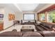 Spacious living room with a large screen, comfortable furniture, and abundant natural light at 6722 S Wolff Ct, Littleton, CO 80128