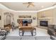 Living room with fireplace, entertainment center, and large windows at 6722 S Wolff Ct, Littleton, CO 80128