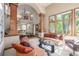 Open living room with large windows and tall pillars showcasing the grand staircase at 6722 S Wolff Ct, Littleton, CO 80128