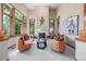 Bright living room featuring a fireplace, ample windows, and comfortable seating at 6722 S Wolff Ct, Littleton, CO 80128