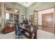 Home office featuring wooden shutters, a large desk, and a cozy seating area at 6722 S Wolff Ct, Littleton, CO 80128
