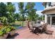 Elevated outdoor deck with a dining area and views of lush greenery and a serene landscape at 6722 S Wolff Ct, Littleton, CO 80128