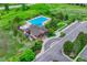 Aerial view of a community pool, clubhouse, and surrounding amenities at 5424 Hacienda Pl, Parker, CO 80134