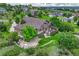 Aerial view of a house with a well-manicured lawn and surrounding landscape at 5424 Hacienda Pl, Parker, CO 80134