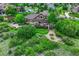 Spacious backyard featuring a large deck, stone patio, and lush greenery at 5424 Hacienda Pl, Parker, CO 80134