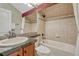 Cozy bathroom featuring tiled walls, a granite countertop vanity, and a shower-tub combo at 5424 Hacienda Pl, Parker, CO 80134