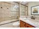 Bathroom features tiled shower, granite vanity, and elegant fixtures at 5424 Hacienda Pl, Parker, CO 80134