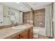 Bathroom featuring a vanity and a shower-tub combo with brown tile at 5424 Hacienda Pl, Parker, CO 80134