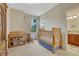 Cozy Bedroom with a wooden crib, rocking chair, and ample natural light at 5424 Hacienda Pl, Parker, CO 80134