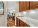Butler's pantry features custom cabinetry, counter space, and stylish tile backsplash at 5424 Hacienda Pl, Parker, CO 80134