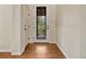Charming entryway with decorative glass door and sleek hardwood floors at 5424 Hacienda Pl, Parker, CO 80134