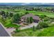 Beautiful exterior featuring a well-kept lawn, mature trees, and an attached garage at 5424 Hacienda Pl, Parker, CO 80134