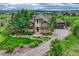 Stunning home with stone accents, a well-manicured lawn, and beautiful landscaping at 5424 Hacienda Pl, Parker, CO 80134