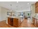 Spacious kitchen with wood cabinets, a large island, hardwood floors, and recessed lighting at 5424 Hacienda Pl, Parker, CO 80134