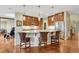 Kitchen with a large island, pendant lighting, stainless steel appliances, and hardwood flooring at 5424 Hacienda Pl, Parker, CO 80134