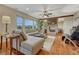 Spacious living room with stone fireplace, beamed ceiling, and scenic backyard views at 5424 Hacienda Pl, Parker, CO 80134