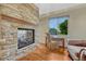 Office space features stone fireplace and a large window with natural light at 5424 Hacienda Pl, Parker, CO 80134