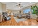 Open living room boasts hardwood floors, neutral decor, and an abundance of natural light at 5424 Hacienda Pl, Parker, CO 80134