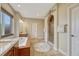 Primary bathroom with soaking tub, dual vanities, tiled floors, and a walk-in shower at 5424 Hacienda Pl, Parker, CO 80134