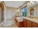 Primary bathroom with dual sinks, vanity, soaking tub and tiled floors at 5424 Hacienda Pl, Parker, CO 80134