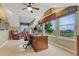 Bright office with a ceiling fan, large windows boasting scenic views and a classic wooden desk at 5424 Hacienda Pl, Parker, CO 80134
