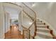 Elegant curved staircase with carpeted steps and ornate wrought iron railing leads to the upper level of the home at 5424 Hacienda Pl, Parker, CO 80134