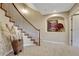 Elegant stairway featuring carpeted steps, a decorative wrought iron railing, and an art niche at 5424 Hacienda Pl, Parker, CO 80134