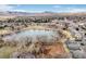 Aerial view of condominium complex near lake with mountain views in the background at 10530 W Jewell Ave # 303, Lakewood, CO 80232
