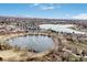 Aerial view of condominium complex near multiple lakes with mountain views in the background at 10530 W Jewell Ave # 303, Lakewood, CO 80232