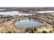Aerial view of condominium complex near lake with mountain views and walking paths at 10530 W Jewell Ave # 303, Lakewood, CO 80232