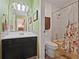 Bathroom with two-tone tile, vanity, framed mirror, and tub with shower at 10530 W Jewell Ave # 303, Lakewood, CO 80232