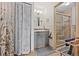 Modern bathroom featuring grey vanity, walk-in shower with glass door, and neutral color tile at 10530 W Jewell Ave # 303, Lakewood, CO 80232